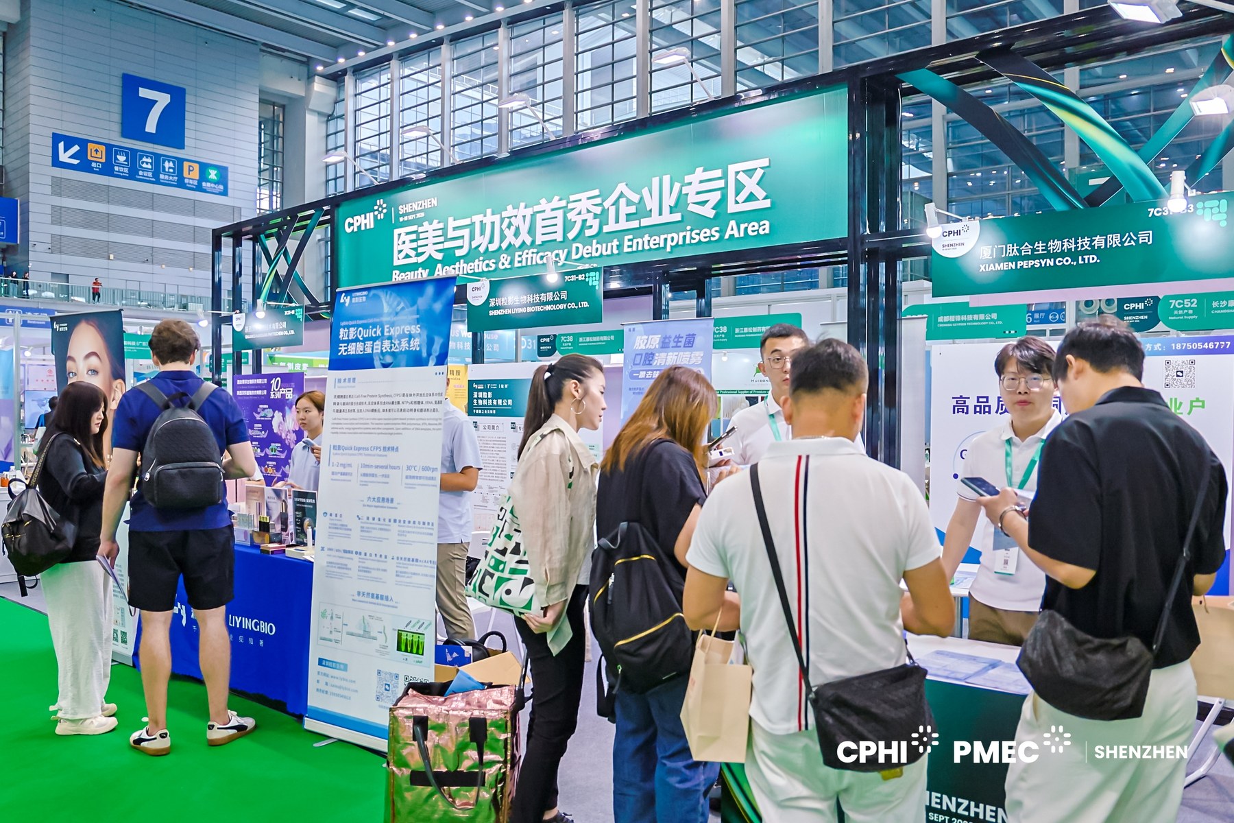 Visitors discussing copper peptide specifications and COA coverage at the PEP-SYN booth